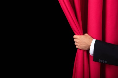 Close-up Of Two Men's Hand Opening Red Curtain clipart