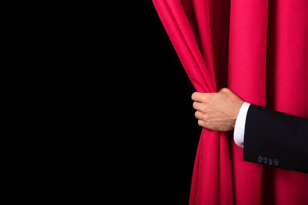Close-up Of Two Men's Hand Opening Red Curtain