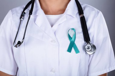 Doctor With Teal Ribbon Supporting Ovarian Cancer Awareness clipart
