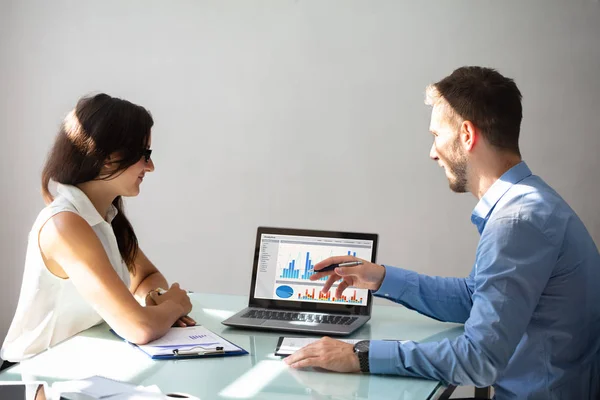 Side View Two Young Businesspeople Discussing Graphs Laptop Workplace — Stock Photo, Image