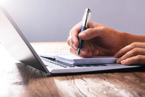 Close Person Hand Writing Spiral Book Laptop — Stock Photo, Image