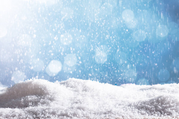 Close-up Of Snow Particles Falling Down Over A Blue Background