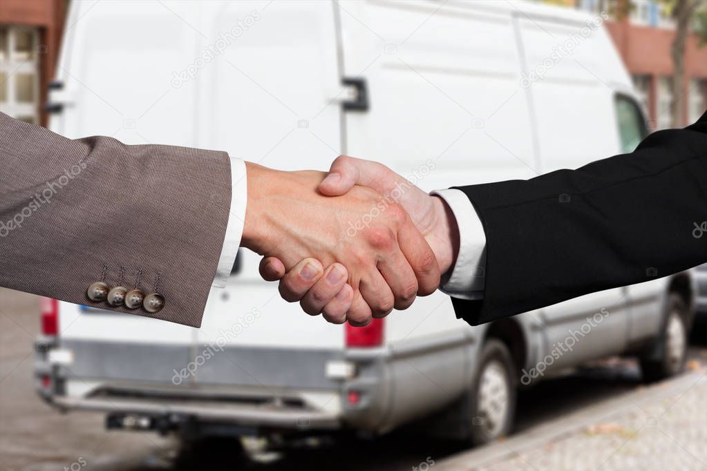 Close-up Of Two Business Partners Shaking Hands At Outdoors