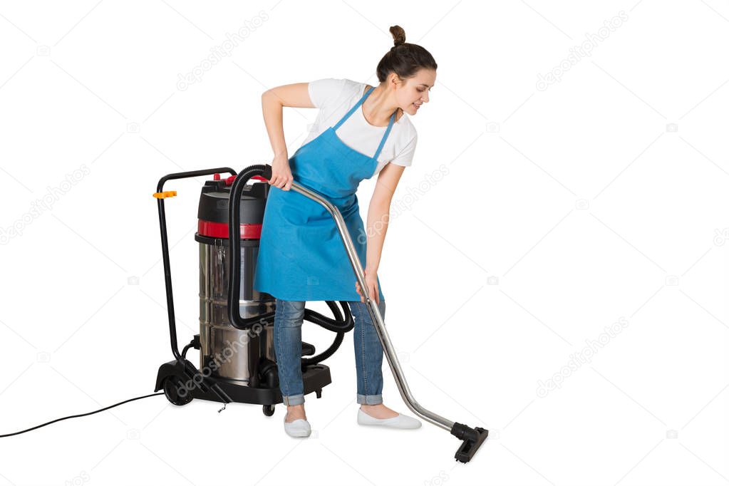 Young Female Janitor Using Vacuum Cleaner On White Background