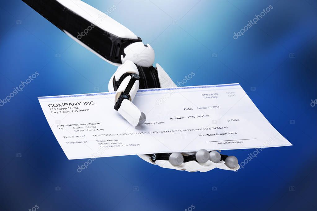 Robotic Hand Holding Cheque On Blue Background