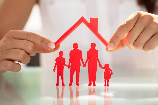 Businesswoman Hand Protecting Red Family Figures Roof Reflective Desk — Stock Photo, Image