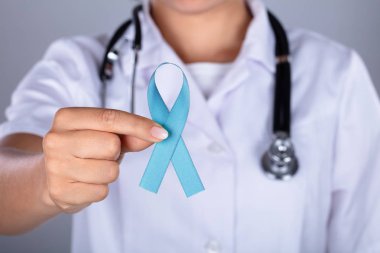 Close-up Of A Female Doctor's Hand Raising Awareness On Ovarian Cancer clipart