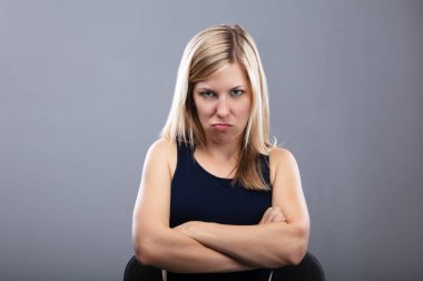 Portrait Of A Angry Young Woman With Folded Arms clipart