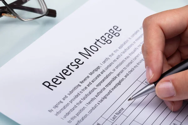 Close Woman Hand Filling Reverse Mortgage Form — Stock Photo, Image