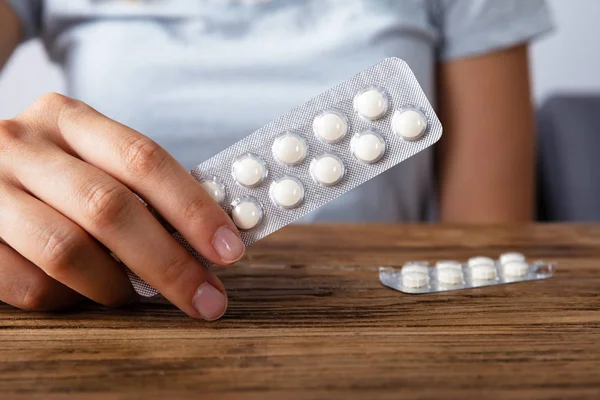 Mano Mujer Sostiene Medicina Sobre Escritorio Madera —  Fotos de Stock