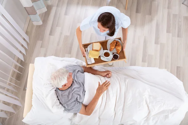 Overhead View Female Nurse Serving Food Senior Male Patient Clinic — Stock Photo, Image