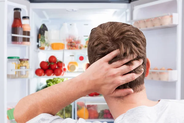 Close Confused Man Looking Food Open Refrigerator — Stok Foto