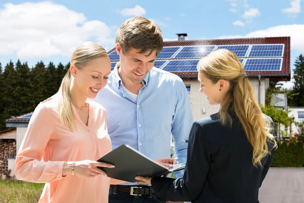 Smiling Female Real Estate Agent Explaining Contract Couple Buying House — Stock Photo, Image