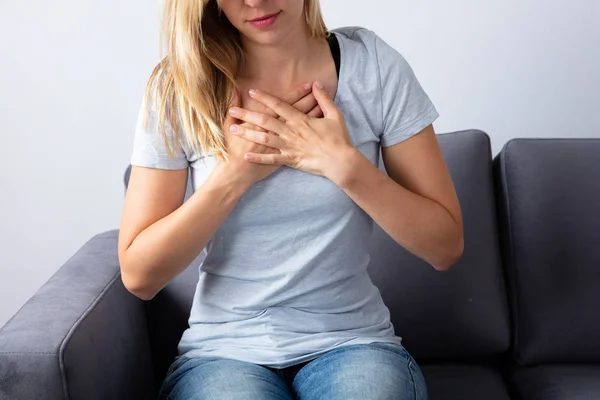 Woman Sitting Sofa Having Chest Pain — Stock Photo, Image