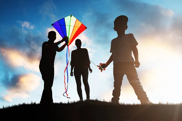 Silhouette Family Playing Colorful Kite Sunset — стоковое фото