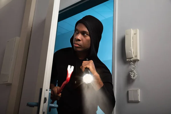 Portrait Thief Hooded Sweatshirt Flashlight Crowbar Entering House — Stock Photo, Image