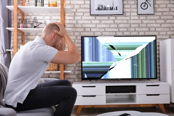 Frustrated Young Man Sitting Sofa Broken Screen — Stock Photo, Image