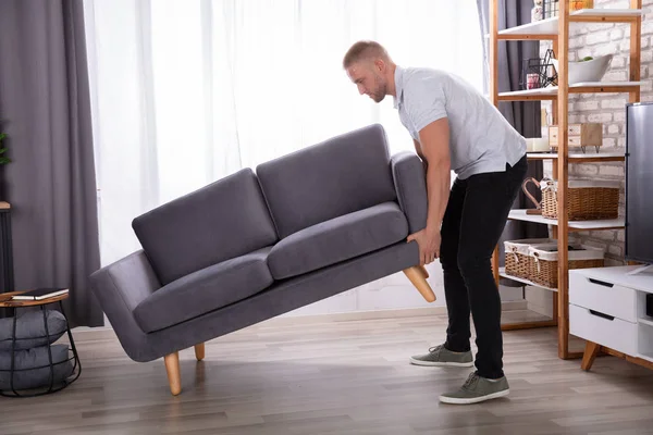 Side View Young Man Lifting Sofa Home — Stok Foto