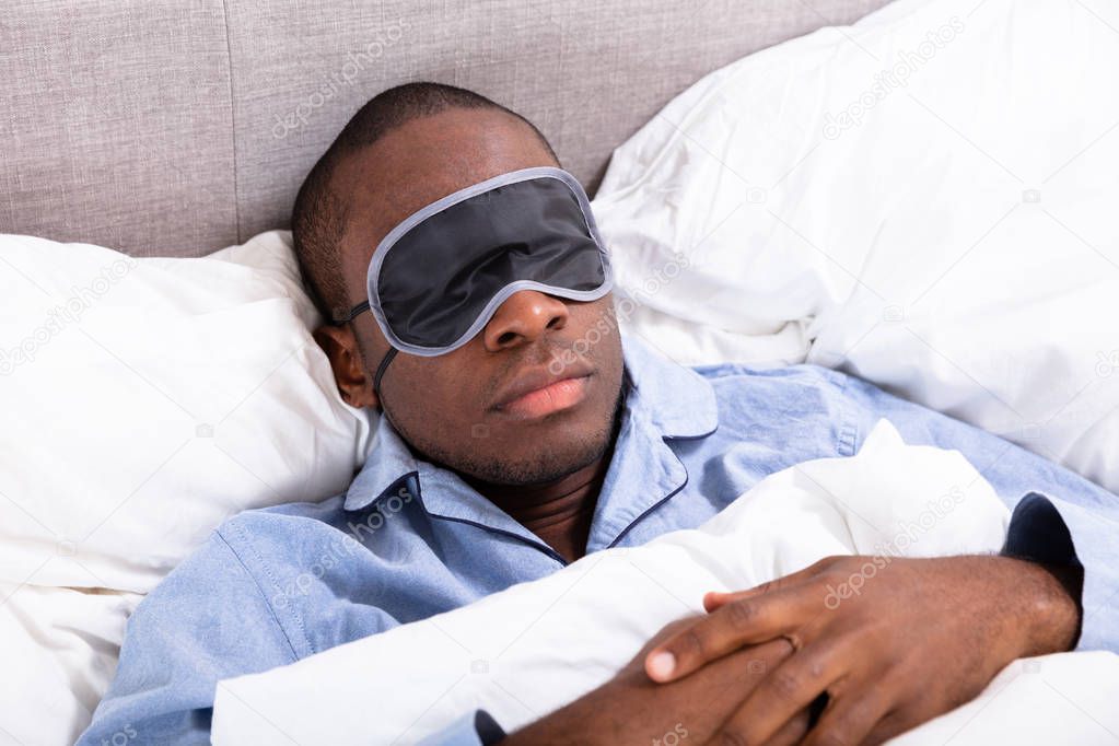 Close-up Of A Young African Man Sleeping With Sleep Mask