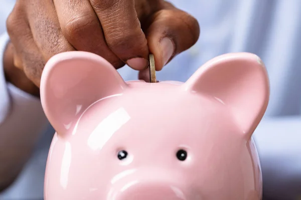 Man Hand Inserting Coin Piggybank Wooden Desk — Stock Photo, Image