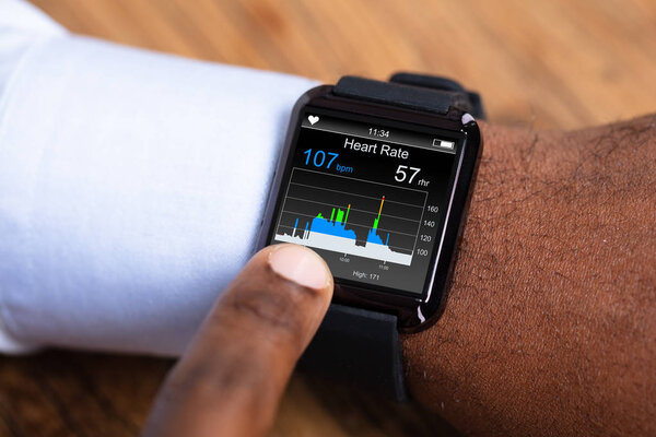 Close-up Of A Man Using Black Smartwatch Showing Heart Rate