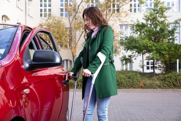 Disabled Young Woman Crutches Opening Door Red Car — Stock Photo, Image