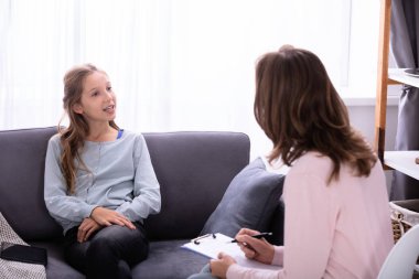 Evde kadın psikiyatrist onun sorunları açıklayan kanepede oturan kız
