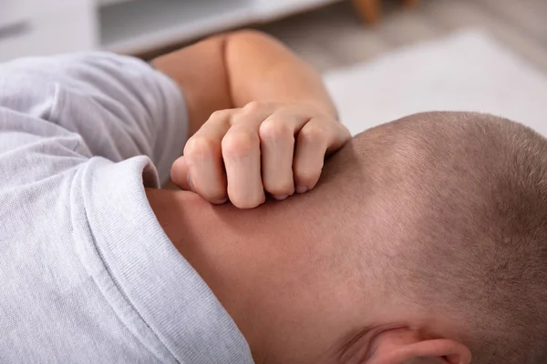 Close-up Of A Man\'s Hand Scratching Itch On His Neck