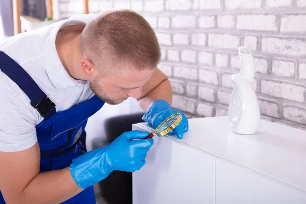 Close Young Male Janitor Examining Cabinet Magnifying Glass — Stock Photo, Image