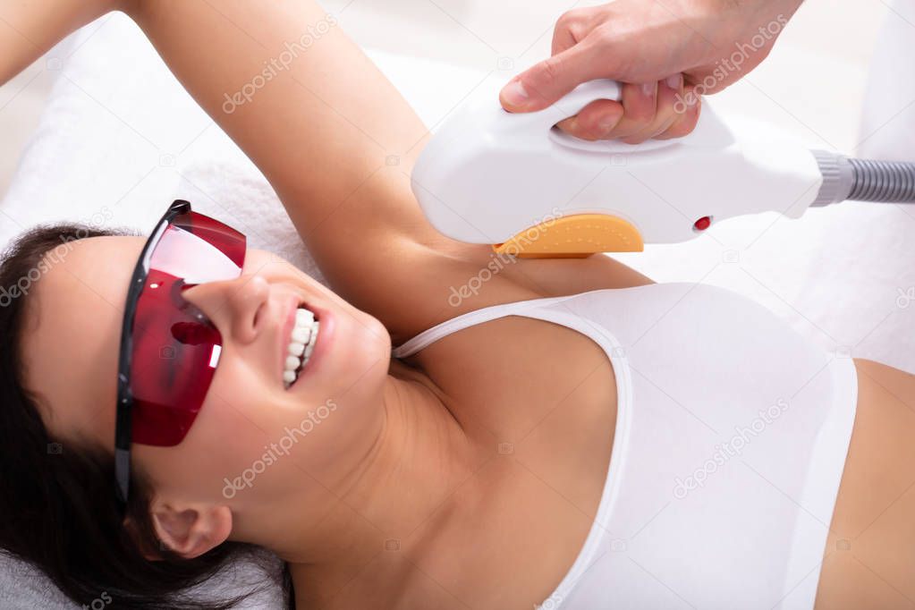 Beautiful Young Woman Having Underarm Laser Hair Removal Treatment In Spa