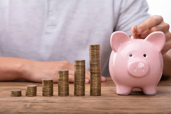 Man Inserting Coin Piggybank Increasing Profit — Stock Photo, Image