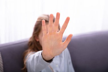 Close-up Of A Girl's Hand Showing Stop Sign clipart