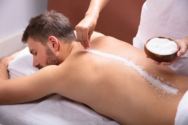 Close Therapist Hand Applying Salt Young Man Back — Stock Photo, Image