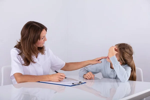 Female Doctor Clipboard Looking Depressed Girl Patient Clinic — Stock Photo, Image