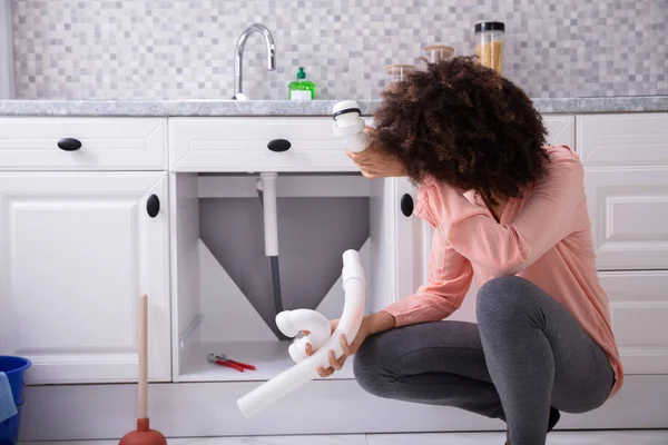 Close Young African Woman Looking Broken White Sink Pipe Kitchen — Stock Photo, Image