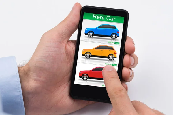 Close-up Of A Person\'s Hand Holding Cellphone With Colorful Cars On Screen
