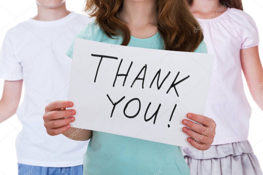 Girl Holding Thank You Placard With Her Friends