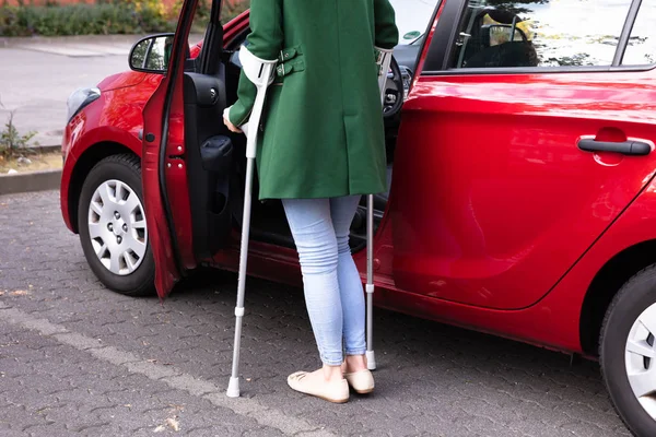 Disabled Young Woman Crutches Opening Door Red Car — Stock Photo, Image