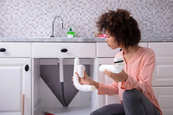 Close Young African Woman Looking Broken White Sink Pipe Kitchen — Stock Photo, Image