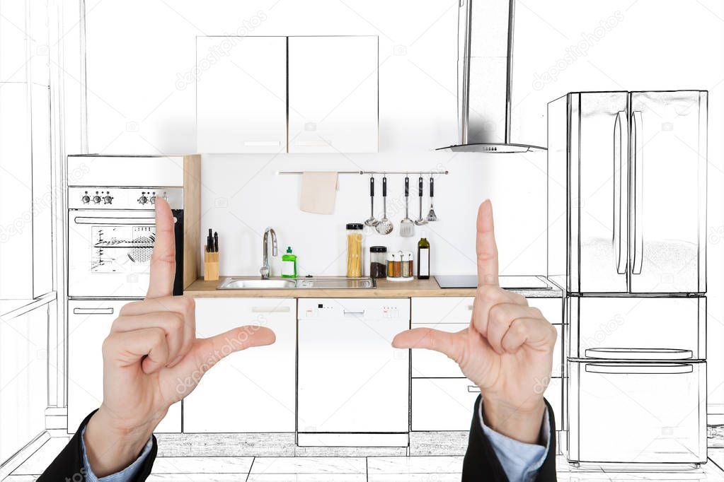 Close-up Of An Architecture's Hand Presenting Design Of Kitchen Interior