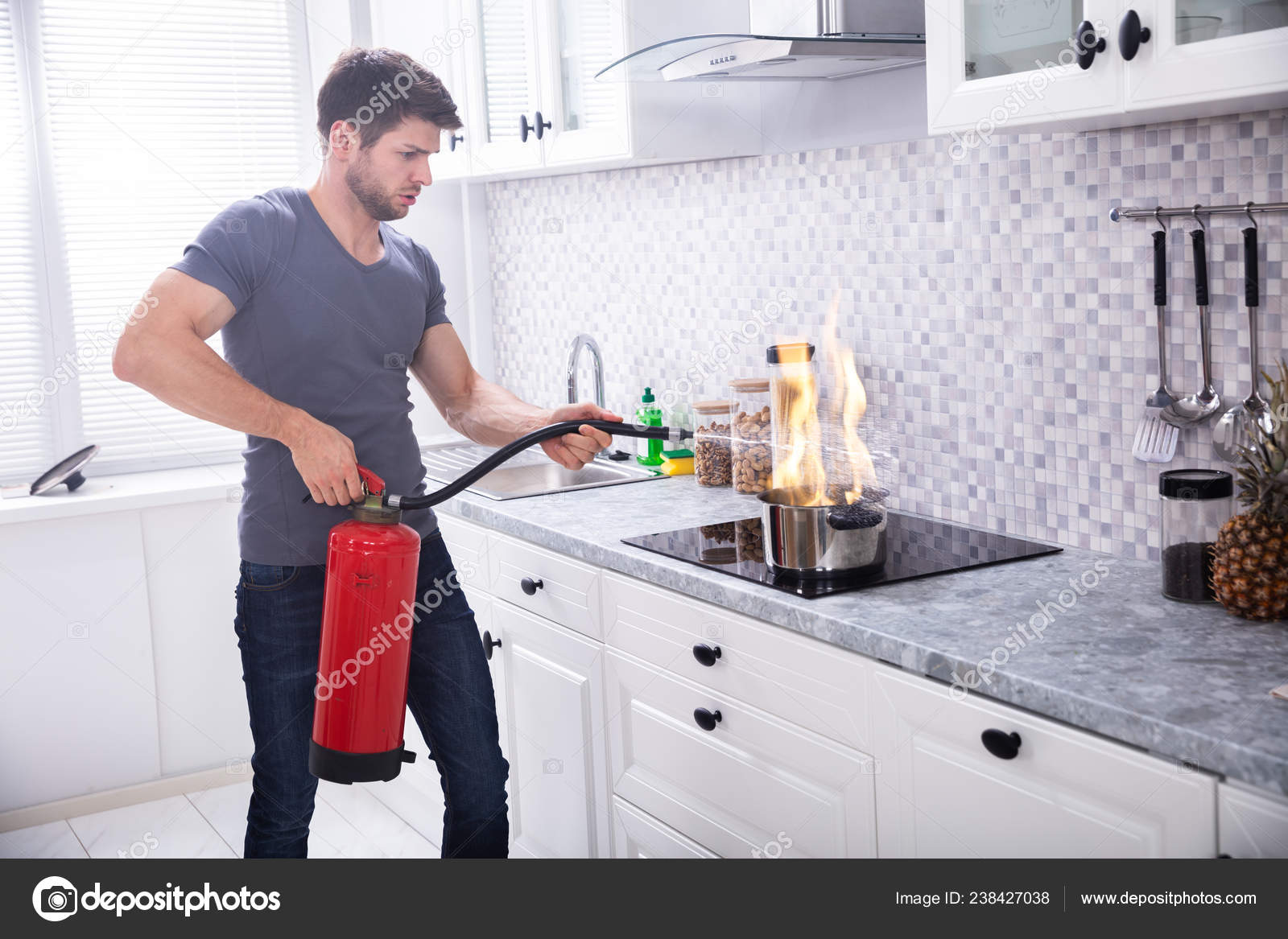 Man Using Fire Extinguisher Stop Fire Burning Cooking Pot Kitchen Stock Photo Image By Andreypopov 238427038