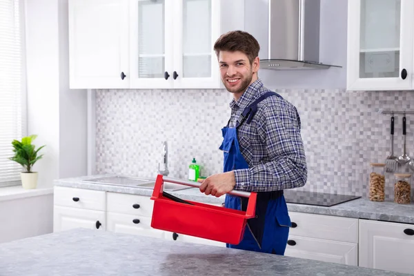 Homem Feliz Reparador Com Caixa Ferramentas Vermelha Cozinha — Fotografia de Stock