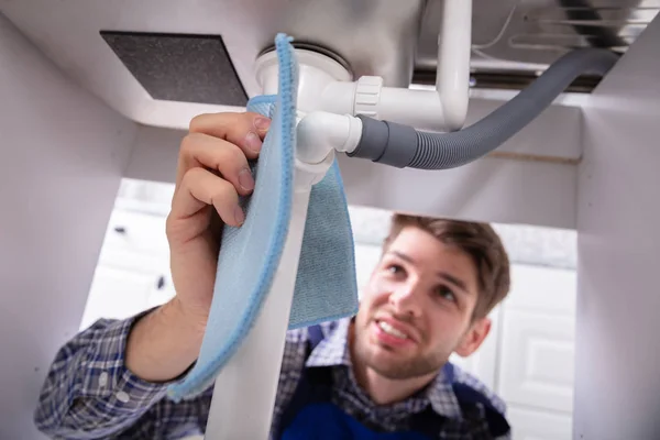 Male Plumber Holding Blue Napkin Stop Sink Pipe Leakage — 스톡 사진