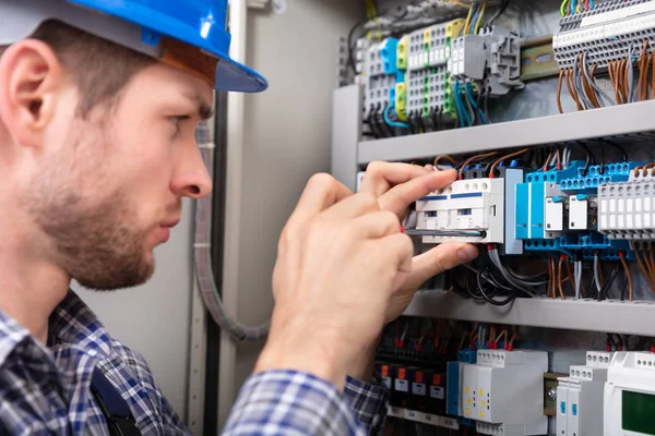 Side View Young Technician Repairing Fuse Box Screwdriver Royalty Free Stock Images