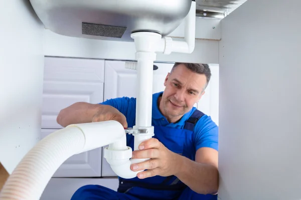 Front View Male Plumber Repairing Sink Pipe Adjustable Wrench — Stock Photo, Image