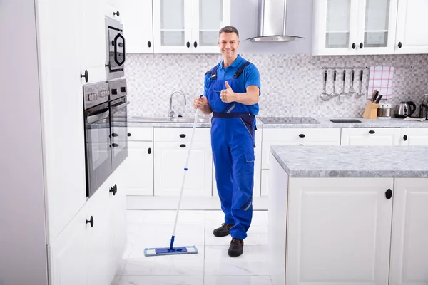 Side View Male Janitor Cleaning White Floor Mop Kitchen — стоковое фото