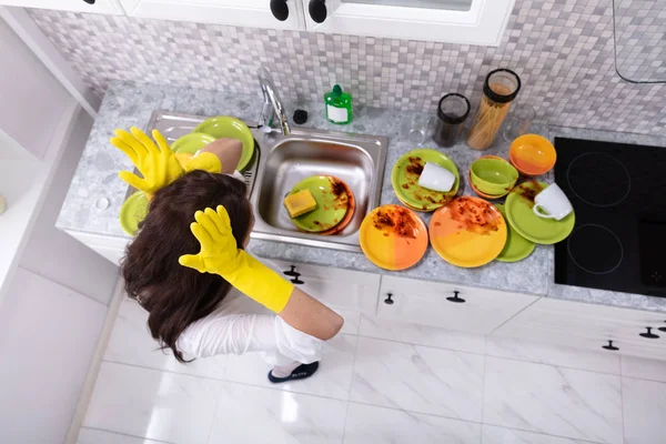 Sad Young Woman Looking Dirty Utensils Sink Kitchen — Stock Photo, Image