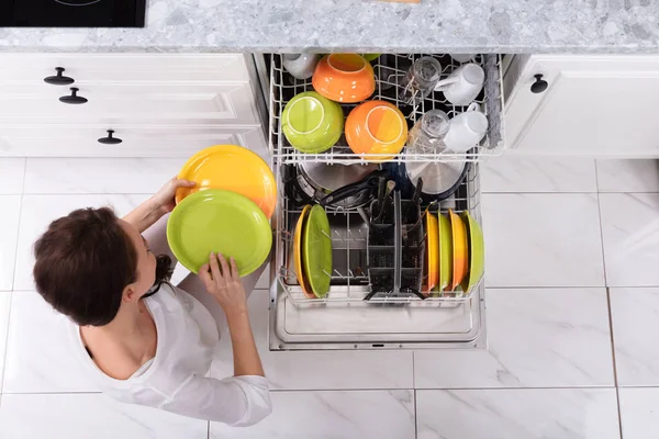 Smiling Young Woman Arranging Plates Dishwasher Home — Stock Photo, Image