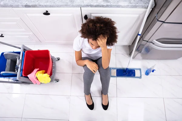 Exhausted African Young Woman Sitting Floor Kitchen — Stock Photo, Image