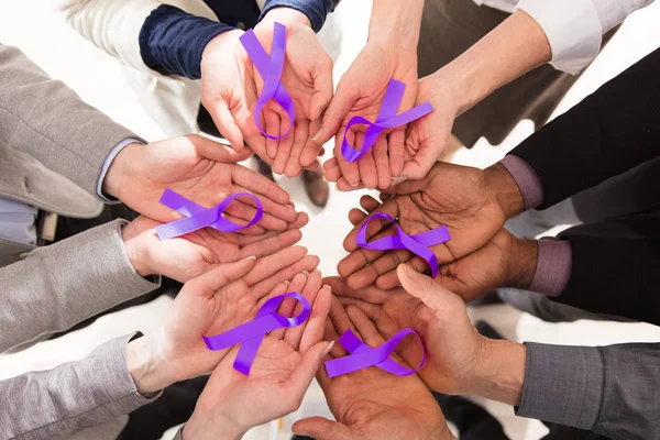 Group Of Businesspeople Holding Teal Ribbons To Support Pancreatic Cancer Awareness